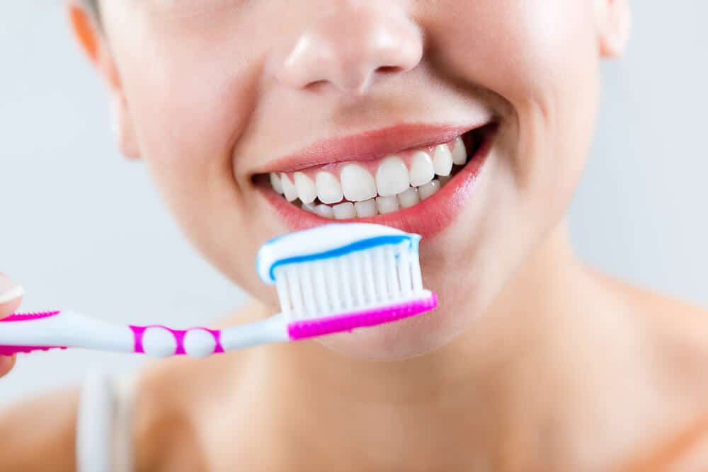 woman brushing teeth